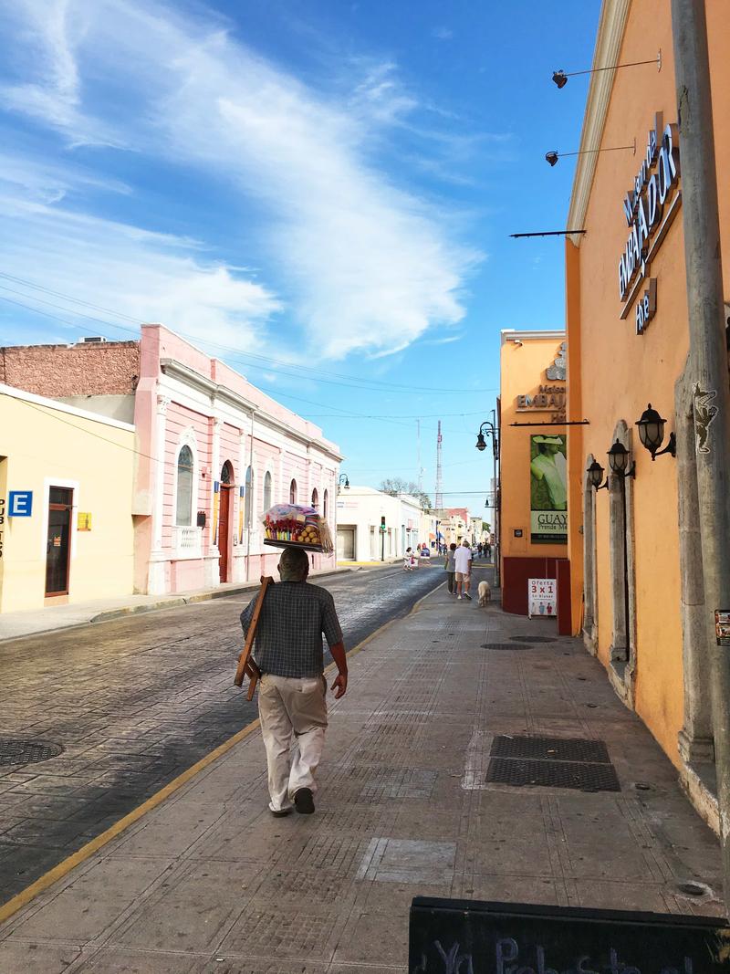 Person balancing food products on their head, Mérida, Yucatán, Mexico