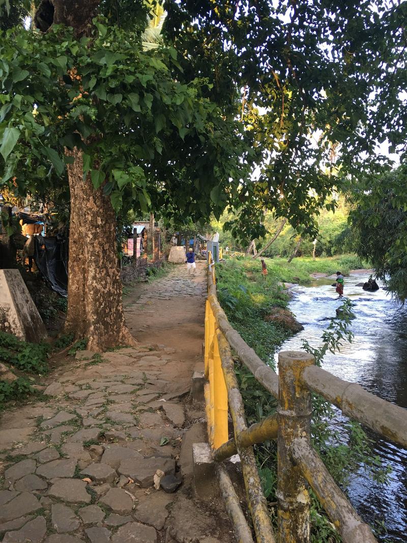 Walking along the water at Vazhachal Waterfalls, Ernakulam, Kerala, India