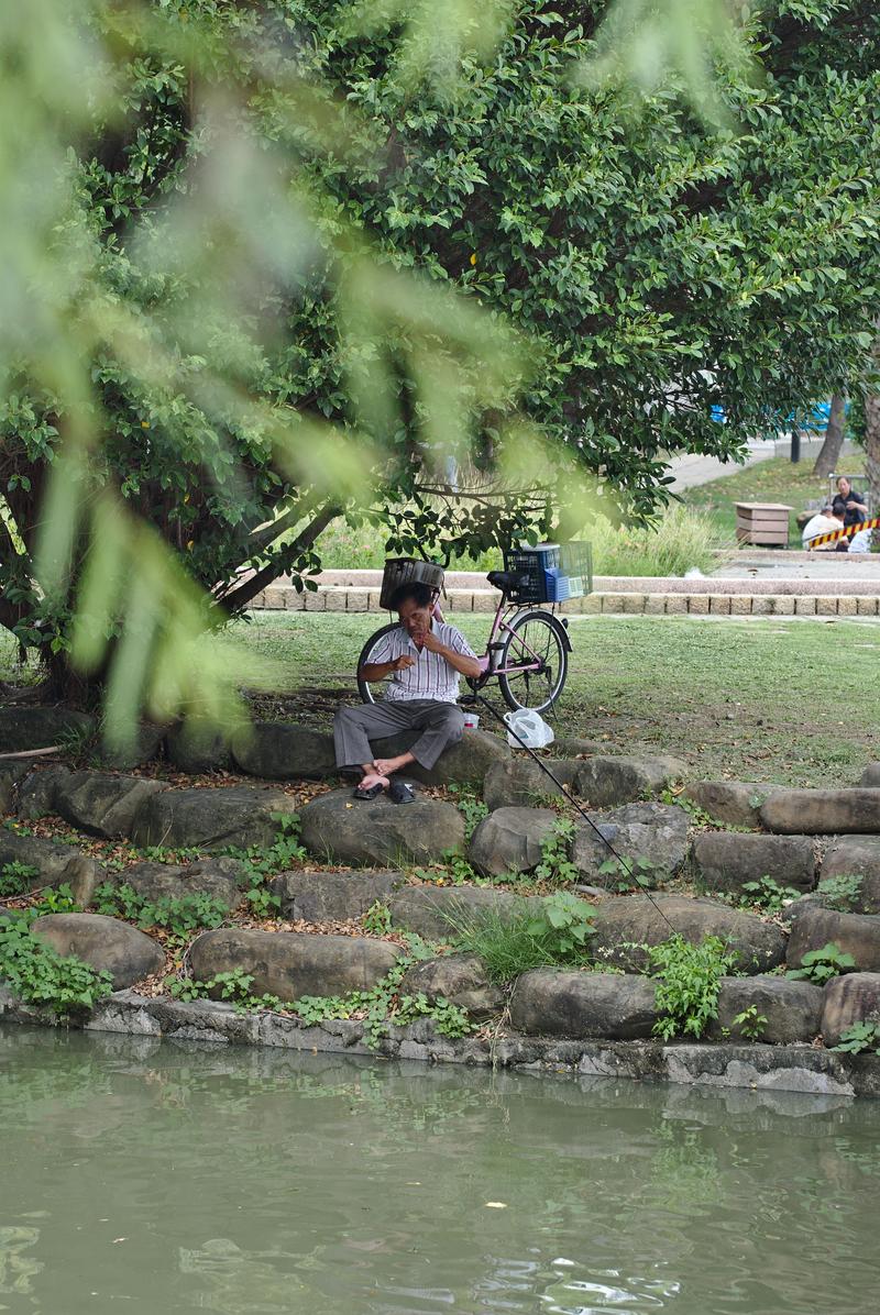 Fisherman baiting his hook near the Lotus Pond, Kaohsiung, Taiwan