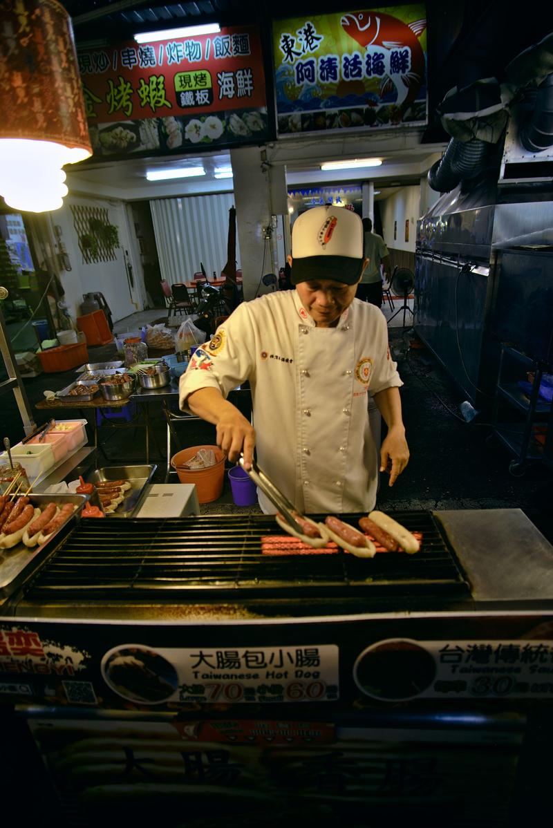 KTaiwanese hot dog vendor at Liuhe Night Market, Kaosiung, Taiwan