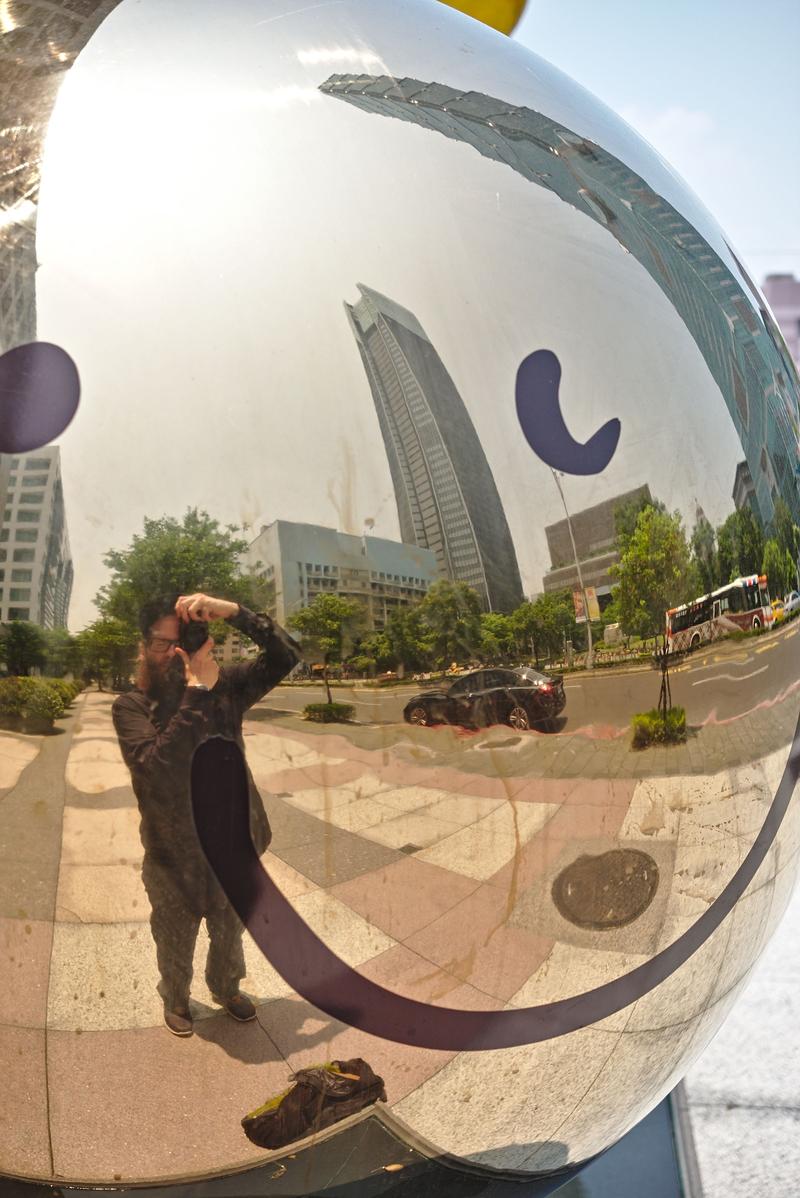 Taipei 101 reflected in happy face reflective ball