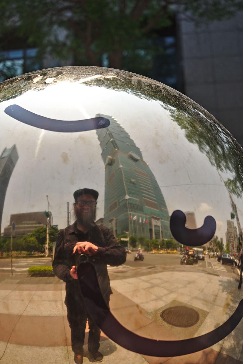 Taipei 101 reflected in happy face reflective ball