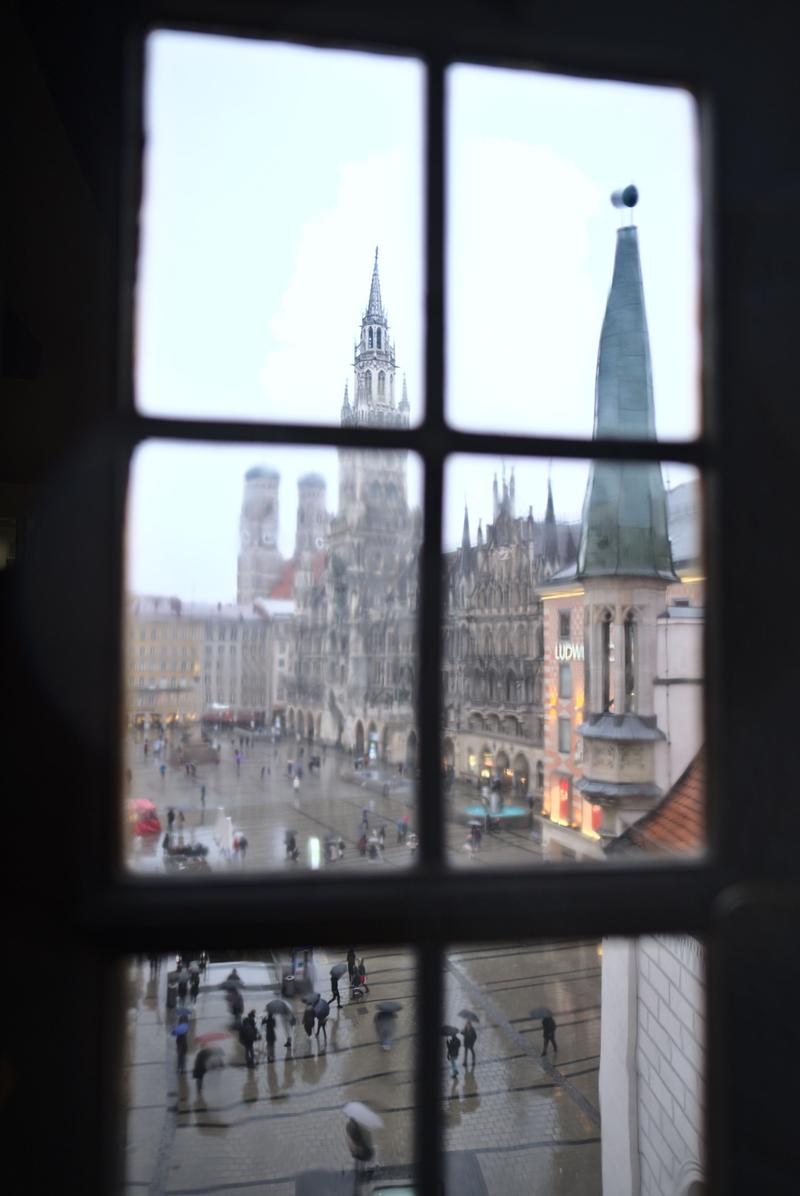 Rathaus-Glockenspiel in Marienplatz viewed through a window in the Spielzeugmuseum (old town hall toy museum), Munich, Germany