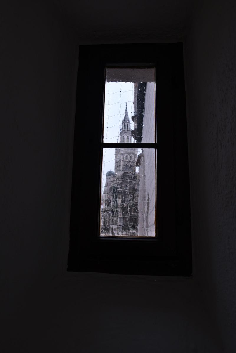 Rathaus-Glockenspiel in Marienplatz viewed through a window in the Spielzeugmuseum (old town hall toy museum), Munich, Germany