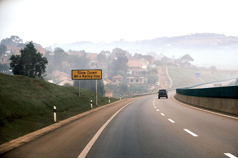 Street view wth sign that reads 'Slow down on a rainy day', Entebbe, Uganda