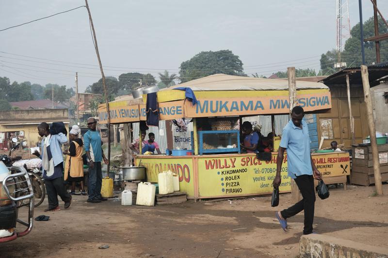 People on the street in front of stores, Uganda