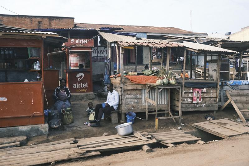 A family and a fruit stand, Uganda