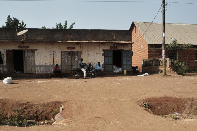 People hanging out in front of homes, Entebbe, Uganda