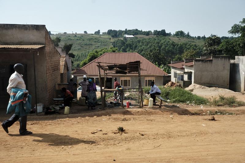 People hanging out in front of homes, Entebbe, Uganda