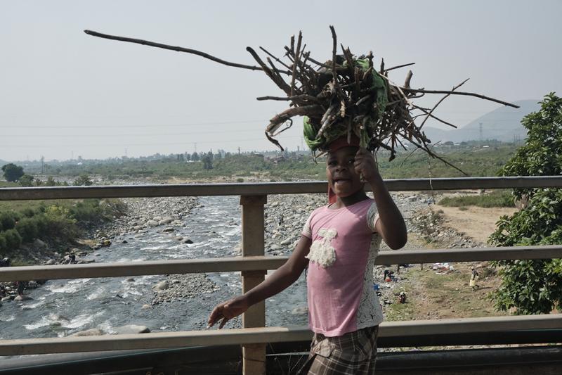 Kids carrying branch bundles on their heads, Uganda