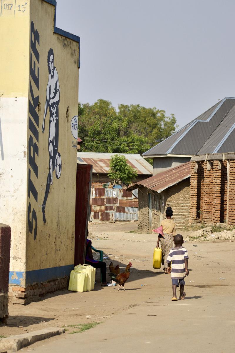 Mother and child walking home, Uganda