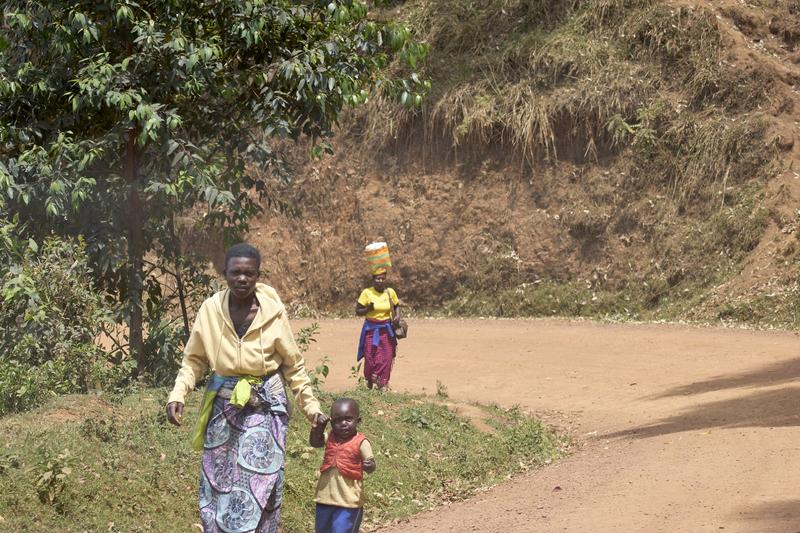 Person carrying a bucket on their head, Uganda