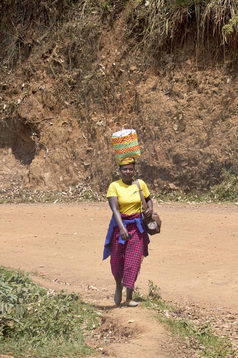 Person carrying a bucket on their head, Uganda