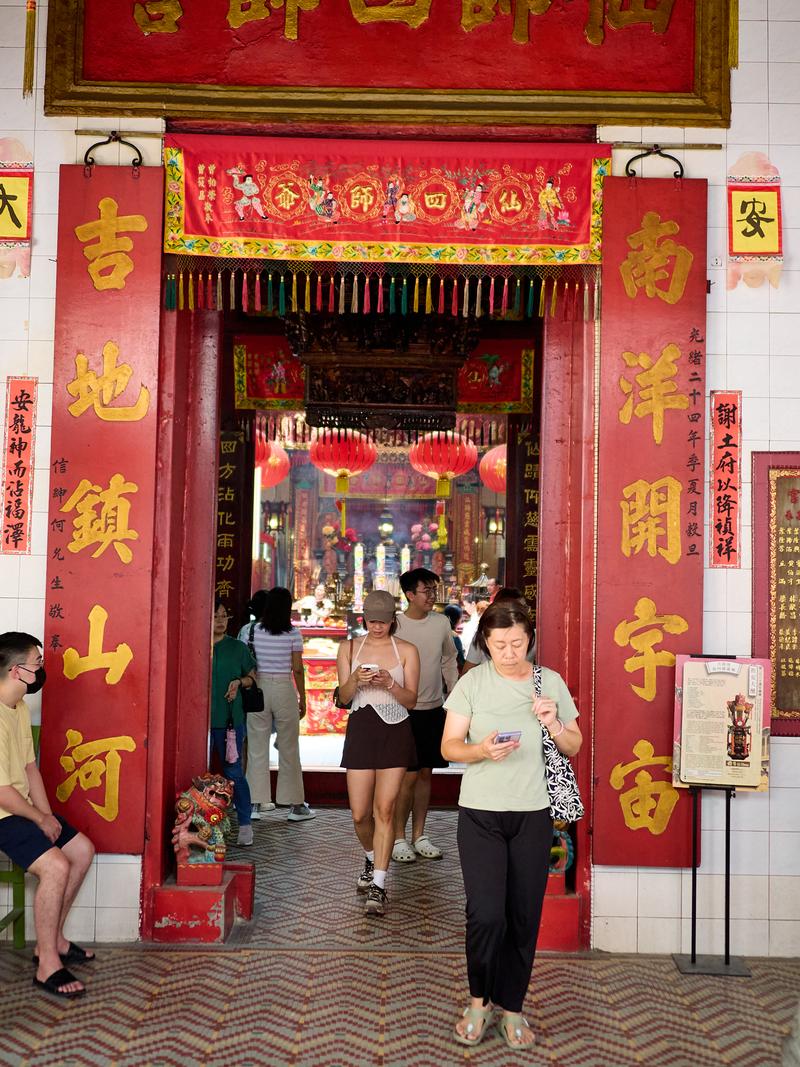 Temple entrance, people walking out of the temple, Kuala Lumpur, Malaysia