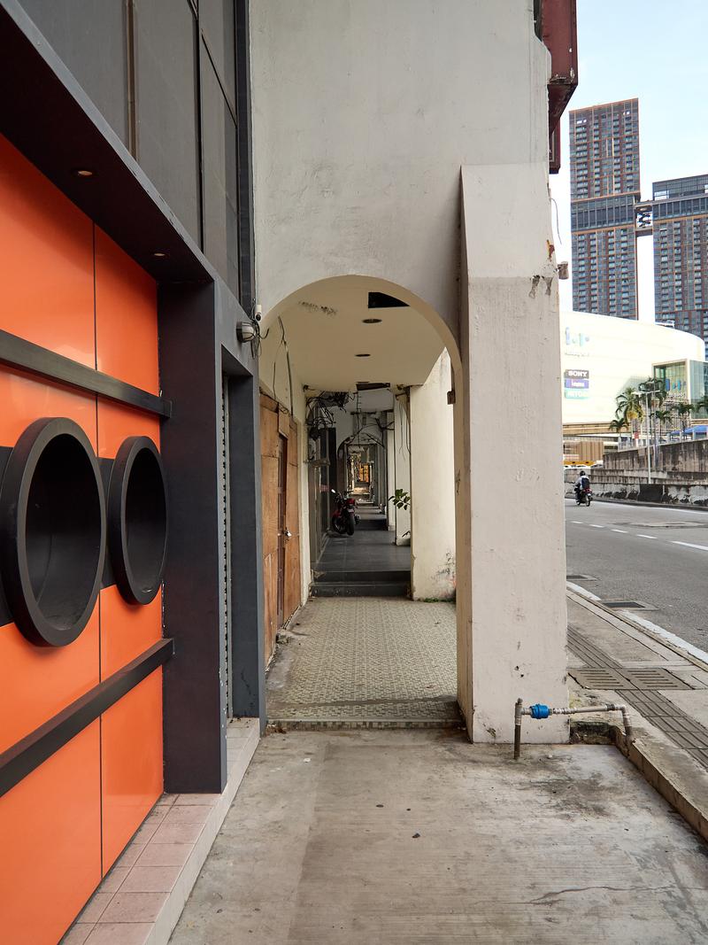 Orange wall covered sidewalk look through, Kuala Lumpur, Malaysia