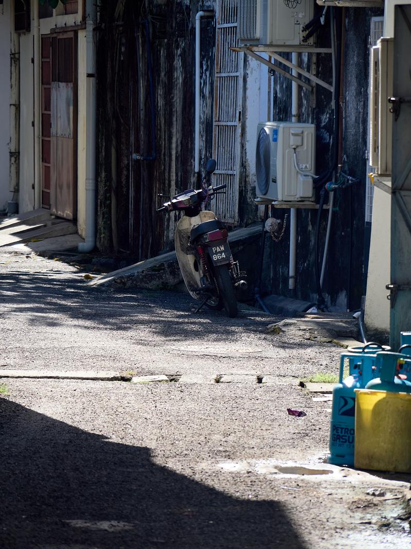 Look through alleyway and motorcycle, strong light, Penang, Malaysia