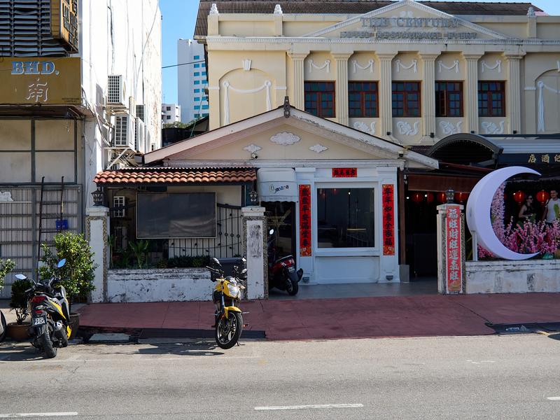 Business front with parked motorcycles, strong light, Penang, Malaysia