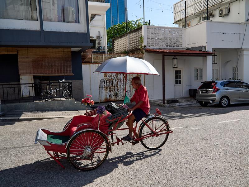 Flowered pedicab and driver, Penang, Malaysia