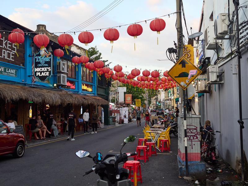 Lanterns strung over the road, striking blue-green building, Penang, Malaysia